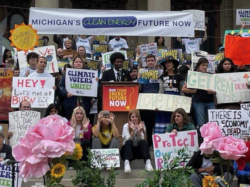 Michael King speaking in front of a crowd of protesters